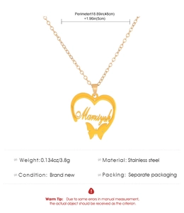 Macro detail of custom heart pendant in gold finish with engraved Marziyeh name and butterfly