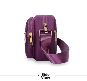 Side view of purple nylon crossbody bag featuring triple-zipper layers and gold hardware
