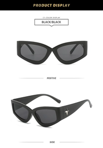 Detail of Y2K cat-eye sunglasses with thick black frames and silver star ornaments