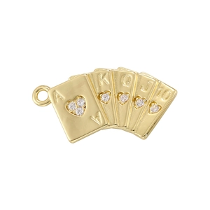 Detailed macro of golden poker flush pendant with heart rhinestones and metallic gloss