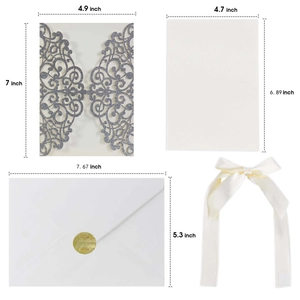 Detail of silver glitter laser cut invitation set with white insert and silk ribbon