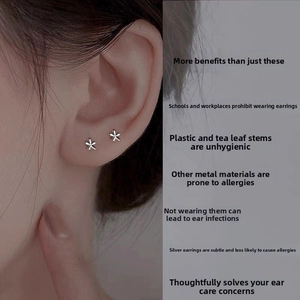 Close-up of minimalist S925 sterling silver flower stud earrings on the ear
