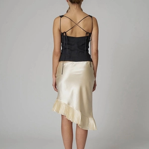 Women's backless black halter top with beige asymmetric pleated mermaid skirt