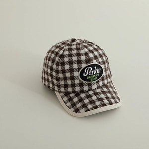 Close-up of retro plaid baseball cap with embroidered oval patch and contrast binding edge