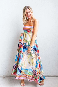 Detail of satin maxi dress with vibrant Oceania map print and palm tree patterns