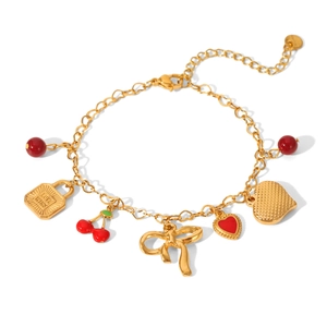 Detail view of gold charm bracelet with red cherries, 'Love Wins' lock and heart pendants
