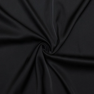 Detailed close-up of premium black fabric texture and elegant drape of the bodycon dress