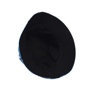Detail of blue bucket hat with Tai Chi pattern and black reversible interior lining
