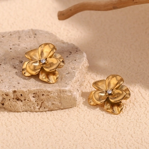 Detailed macro view of 18K gold-plated double-layer flower earrings with zircon