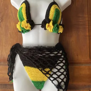 Detailed close-up of handmade crochet bikini set with black, yellow, and green knit texture