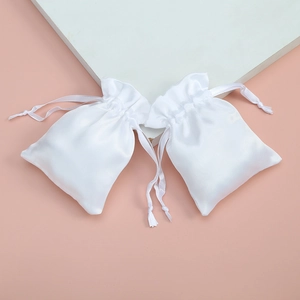 Elegant white satin drawstring pouches for jewelry storage and gift packaging display