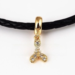 Macro shot of 18K gold plated flower pendant with white zircon inlays on black cord