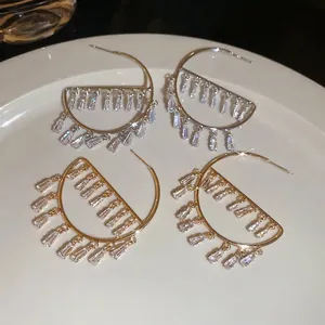 Silver needle hoop earrings with gold and silver cubic zirconia fringe pendants