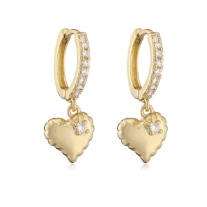 Detail of golden hoop earrings with sparkling heart pendant and cubic zirconia accents
