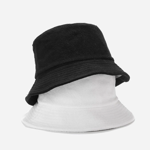 Solid color bucket hat in black and white textured terry cloth fabric for men and women