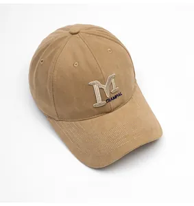 Detail of khaki cotton baseball cap showing 3D M and CHAMPAL embroidery on front