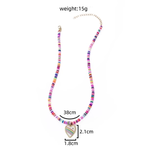 Colorful clay bead necklace with gold heart pendant featuring rainbow design