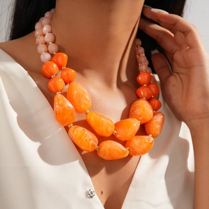 Double-layered chunky acrylic necklace with orange and pink marbled irregular beads