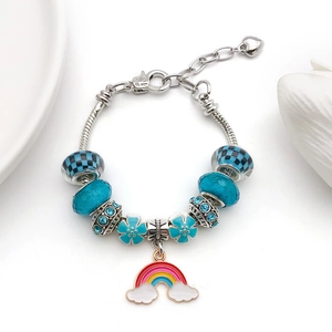 Close-up of blue and silver charm bracelet with rainbow pendant and crystal beads
