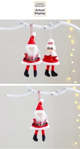 Detailed plush Santa and Mrs. Claus hanging dolls with festive red outfits and ropes