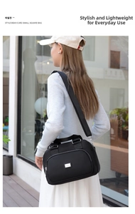 Detail of black waterproof nylon crossbody bag with silver zippers and adjustable strap