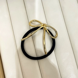 Minimalist black hair tie with a golden metal wire bow hair accessory for women