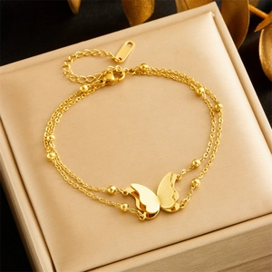 Double-layered stainless steel chain bracelet with gold butterfly pendant and beads
