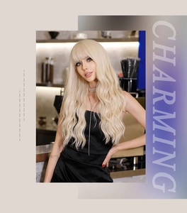 Detail of long wavy platinum blonde wig with bangs on a model in a black dress