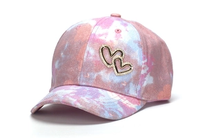 Detail view of colorful tie-dye children's baseball cap with rhinestone heart design