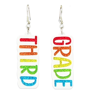 Detail view of colorful glitter acrylic earrings featuring THIRD GRADE lettering charms