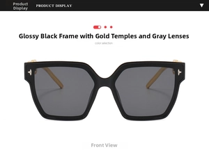 Detail of square black frame sunglasses with golden metal temples and star rivets