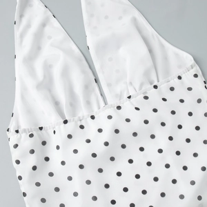 Detailed view of polka dot halter top with deep V-neckline and neat stitching