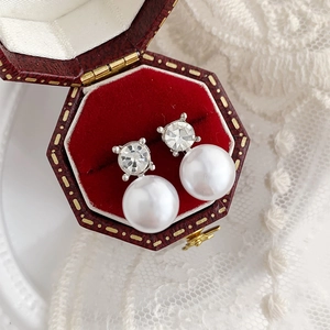Exquisite pearl stud earrings with sparkling zircons in a vintage red velvet jewelry box