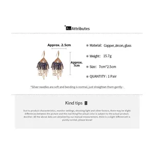 Detailed view of zircon star and water drop fringe earrings with size measurements