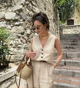 Detail of V-neck linen vest with buttons and matching shorts in beige casual set