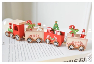 Macro detail of a wooden Christmas train set on a book with festive holiday decor