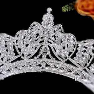 Close-up of elegant silver bridal crown with intricate cutout design and rhinestones