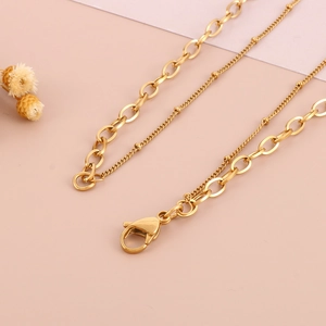 Detail of gold-plated stainless steel layered chain necklace with lobster clasp