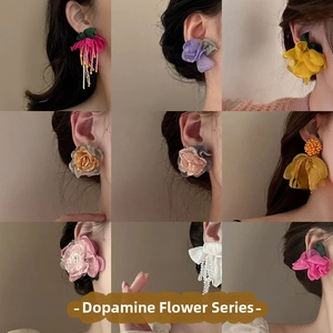 Detail shots of floral earrings collection with mesh roses and tassel accents