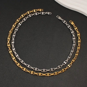 Detailed top view of gold and silver cross geometric chain necklaces on black texture
