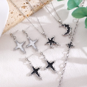 Y2K gothic jewelry set featuring moon and cross charms with black enamel finish