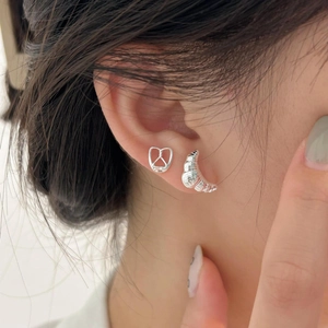 925 Sterling silver croissant and pretzel stud earrings set on a female model