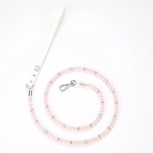 Detail of luxury pink pearl pet leash with silver rhinestones and white leather handle
