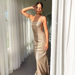 Detailed view of the sparkling champagne gold sequins on a backless evening dress