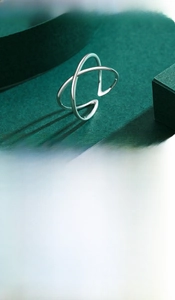 Detailed close-up of polished S925 sterling silver minimalist geometric crossover ring