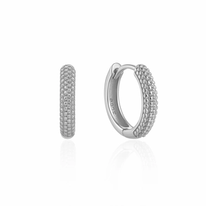 Detailed macro shot of textured S925 sterling silver hoop earrings with mirror reflection