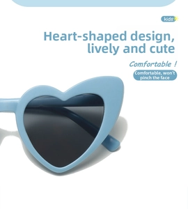 Close-up of light blue heart-shaped kids sunglasses with UV protective lenses