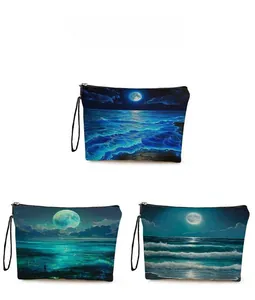 Three zippered canvas pouches featuring ocean moonlight prints for makeup and toiletries