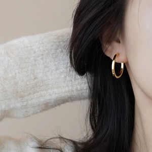 Elegant gold S925 sterling silver hoop earrings shown on a model for a chic French look