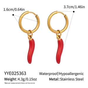 Detailed view of red chili pepper drop earrings in 18K gold plated stainless steel